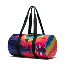 Load image into Gallery viewer, Angled front view of the Rainbow Tie-Dye bag with the black shoulder straps pulled up.