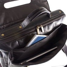 Load image into Gallery viewer, Angled close up to the back panel pockets under the flap closure of the brown leather messenger bag.