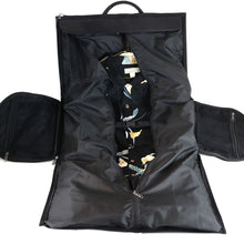 Load image into Gallery viewer, The black leather duffle bag fully opened with the garment section storing a button up shirt.