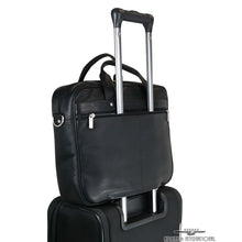 Load image into Gallery viewer, The black briefcase's back panel strap attached to the telescopic handle of a suitcase.
