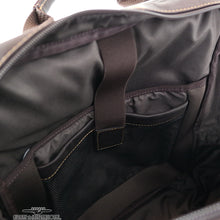 Load image into Gallery viewer, Interior view of the brown leather backpack. It features a laptop and tablet compartment.