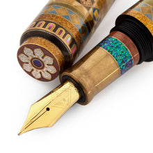 Load image into Gallery viewer, Close up to the grip section, the fountain pen nib, and the top of the cap, which is placed next to the pen on a white background. The grip section features a ring composed of small abalone shell pieces. The nib has an engraving of the AP logo and the 18K - 750 Gold stamp.