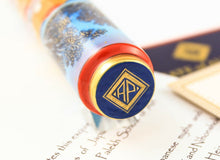 Load image into Gallery viewer, Close up to the AP Limited Editions Logo painted a top the cap. Set on the assorted documents.