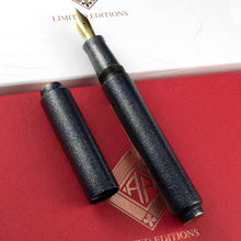 Load image into Gallery viewer, The fountain pen with the cap placed next to it. Both are set on top of the red presentation box and the white outer box.