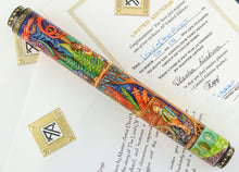 Load image into Gallery viewer, View of the fountain pen on top of the certificates. This side views a hobbit by some fireworks, and some foliage on the background.