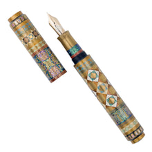 Load image into Gallery viewer, Front view of the Fountain Pen with the cap set to the side on a white background. A series of intricate geometric-styled designs surround the pen. A combination of gold powders, raden, and other techniques were used in the making of the pen.