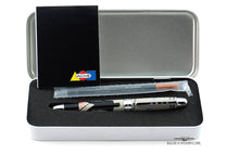 Load image into Gallery viewer, View of the inside of the case with the pen in its slot, the included pamphlet, and a refill. Set on a white background.