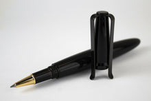 Load image into Gallery viewer, The pen laying on a white surface with the cap standing in front of it.
