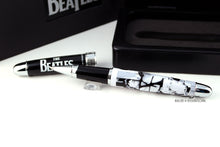Load image into Gallery viewer, Close up to the first rollerball The cap is black, and has The Beatles logo in white. The barrel has a design of each member in white, black, and light gray.