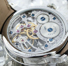 Load image into Gallery viewer, Close up to the back of the clock. It is a skeleton, which allows for the insides to be seen.