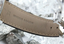Load image into Gallery viewer, Close up to one of the leather straps. The inside is a light tan color with two embossings: The number 22, and "SWISS MADE".