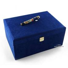 Load image into Gallery viewer, The Fountain pen placed on top of the blue presentation box. Set on a white background.