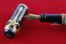 Load image into Gallery viewer, Close up to the Fountain pen nib and the cap. The nib has an elaborate engraving with decorations, the year 1919, the Ancora anchor logo, a 750 18k gold stamp, and the M for the nib size.