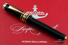 Load image into Gallery viewer, Front view of the Fountain Pen with the cap on. Set on top of the red document included.
