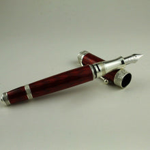 Load image into Gallery viewer, Front view of the fountain pen with the grip section leaning on the cap. Set on a white background.