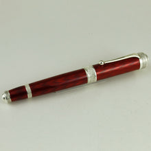 Load image into Gallery viewer, Side view of the fountain pen on a white background. 
The body is a ruby-red with a diamond-shaped guilloche design on it. 
The trims are silver on the top of the cap, clip, cap ring and bottom of the pen.