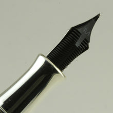 Load image into Gallery viewer, Back view of the fountain pen nib on a white background. The feed is black and has an engraved 'M' for the nib point.