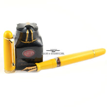 Load image into Gallery viewer, Arrangement of the yellow Fountain Pen with the cap and ink bottle set next to it. Placed on a white background.