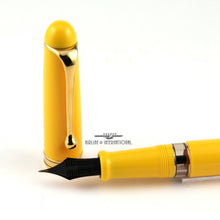 Load image into Gallery viewer, Close up to the fountain pen cap and the feed of the pen on a white background. above the grip section, there is a small "demonstrator" window which allows you to see the ink's color.