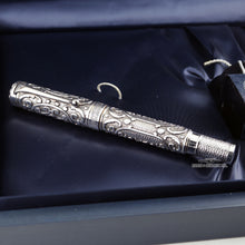 Load image into Gallery viewer, Front view of the fountain pen with the cap on. Placed in the presentation box. The body is made of sterling silver, and features elaborate decorations and textures around the body. The cap ring has an engraving with the word "AURORA".