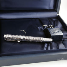 Load image into Gallery viewer, Side view of the fountain pen and angled view of the ink bottle on the presentation box. Placed on a white background.