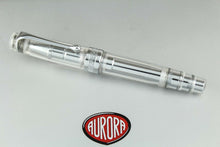 Load image into Gallery viewer, Front view of the pen on top of the presentation box. It is a transparent model which allows the inside to be seen. It has chrome trims on the clip and cap ring.