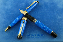 Load image into Gallery viewer, The Fountain pen with the cap off, and the ballpoint pen arranged on top of the blue felt presentation box.