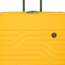 Load image into Gallery viewer, Close up to the top front of the mango yellow suitcase.