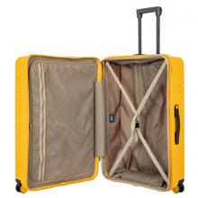 Load image into Gallery viewer, Interior view of the mango yellow suitcase. The lining is light brown. The front panel side features a zipper-closing compartment, and the back panel features a set of straps to hold contents in place.