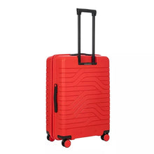 Load image into Gallery viewer, Angled back view of the red 30 inch suitcase on a white background. The panel features a design with wave lines and black accents.