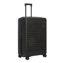 Load image into Gallery viewer, A matte, hard-shell black 30 inch suitcase with a textured wave pattern on the front. It has four spinner wheels, a retractable handle, and a small circular logo on the front.
