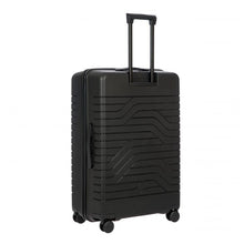Load image into Gallery viewer, A matte, hard-shell black 30 inch suitcase with a textured wave pattern on the back. It has four spinner wheels, a retractable handle, and a side handle.