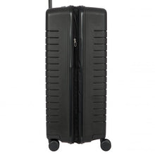 Load image into Gallery viewer, Side view of a matte black hard-shell suitcase on a white background. The expandable feature is zipped open.