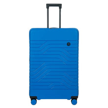 Load image into Gallery viewer, Front view of the 30 inch Electric Blue Spinner suitcase on a white background. It features a wave lines design, black trims, and a small black circle with the BY logo at the top right.