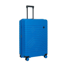 Load image into Gallery viewer, Front angled view of the 30 inch electric blue suitcase on a white background. It features a wave lines design and black trims.