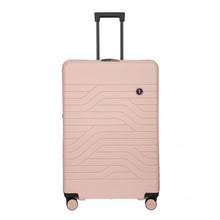 Load image into Gallery viewer, Front view of a matte, hard-shell pink suitcase with a textured wave pattern on the front. The black telescopic handle is pulled up. A small circular logo with the letters BV is at the top right.