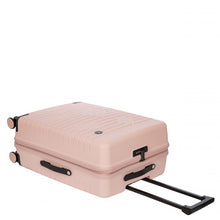 Load image into Gallery viewer, A hard-shell pink suitcase laid on its back. The telescopic handle is retracted.