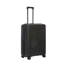 Load image into Gallery viewer, Angled front view of the black hard shelled suitcase. It has a textured wave lines The telescopic handle is pulled up.