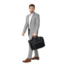 Load image into Gallery viewer, Briggs & Riley Baseline Underseat Duffle - Black
Image of male model carrying the Black Underseat Duffle.  
Height	     Width	     Depth	    Weight
US	10.5 in.	16.5 in.	11.5 in.	2.8 lbs.
EU	26.7 cm	41.9 cm	29.2 cm	1.3 kg
