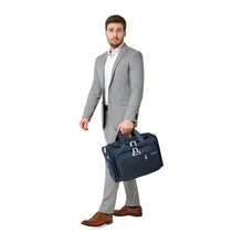 Load image into Gallery viewer, Briggs & Riley Baseline Underseat Duffle - Navy
Image of male model carrying Navy Underseat Duffle.
Height	     Width	     Depth	    Weight
US	10.5 in.	16.5 in.	11.5 in.	2.8 lbs.
EU	26.7 cm	41.9 cm	29.2 cm	1.3 kg