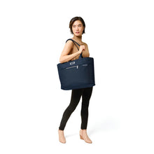 Load image into Gallery viewer, Briggs & Riley Baseline Travel Tote - Navy
Image of Travel Tote hanging on female model's shoulder
Height	     Width	     Depth	     Weight
US	13 in.      21 in.       7.5 in.     1.6 lbs.
EU	33 cm    53.3 cm	19.1 cm	0.7 kg