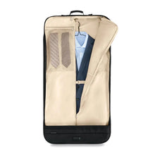 Load image into Gallery viewer, Briggs & Riley Baseline Classic Garment Cover - Black
Image of Interior Curtain partially zipped open. Showing a suit hanging and two ties folded in left mesh pocket.
Height Width Depth Weight
US 22.5 in. 24.5 in. 2 in. 3.2 lbs.
EU 57.2 cm 62.2 cm 5.1 cm 1.5 kg