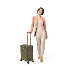 Load image into Gallery viewer, Briggs & Riley Baseline Global Carry-On Spinner - Olive
Image of female model wheeling the Olive Baseline Global Carry-On Spinner
Height	     Width	     Depth	       Weight
US	21 in.       15 in.	9 in.	         9.9 lbs. 
EU	53.3 cm	38.1 cm	22.9 cm	 4.5 kg