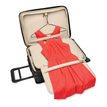 Load image into Gallery viewer, Briggs & Riley Baseline Essential 2-Wheel Carry-On - Black
Image of tri-fold garment folder in lid compartment with roll bar to minimize wrinkling. Shown with full length dress in hanging position.
 
Height	     Width	     Depth	     Weight
US	22 in.	14 in.	9 in.	        9.7 lbs.
EU	55.9 cm	35.6 cm	22.9 cm	4.4 kg