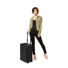 Load image into Gallery viewer, Briggs & Riley Baseline Essential 2-Wheel Carry-On - Black
Image of Essential 2-Wheel Carry-On shown with female model.
 
Height	     Width	     Depth	     Weight
US	22 in.	14 in.	9 in.	        9.7 lbs.
EU	55.9 cm	35.6 cm	22.9 cm	4.4 kg