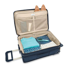 Load image into Gallery viewer, Briggs & Riley Baseline Essential 2-Wheel Carry-On - Navy
Image of Main Compartment shown in non-expanded position.  Also features lip compartment with suiter and two zip mesh pockets.
Height	     Width	     Depth	     Weight
US	22 in.	14 in.	9 in.	        9.7 lbs.
EU	55.9 cm	35.6 cm	22.9 cm	4.4 kg