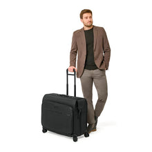 Load image into Gallery viewer, Briggs & Riley Baseline Deluxe Wardrobe Spinner - Black
Image of Deluxe Wardrobe Spinner being wheeled by male model.
Height	     Width	     Depth	     Weight
US	23 in.	24.5 in.	13.5 in.	16 lbs.
EU	58.4 cm	62.2 cm	34.3 cm	7.3 kg