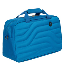 Load image into Gallery viewer, Front angled view of the electric blue duffle bag on a white background. The front and back panels feature a wave line design.