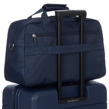 Load image into Gallery viewer, The duffle's back strap can be sliped into a suitcase's telescopic handle to keep it in place.