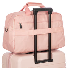 Load image into Gallery viewer, The back strap of the duffle bag can be used to be held in place by a suitcase's telescopic handle.